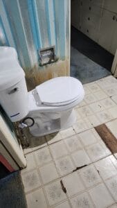 A toilet in a bathroom.