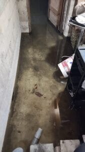 A basement with a flooded floor.