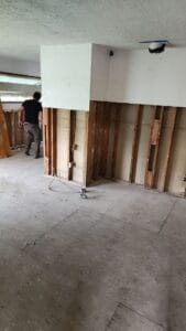 A man is working on a room that is being remodeled.